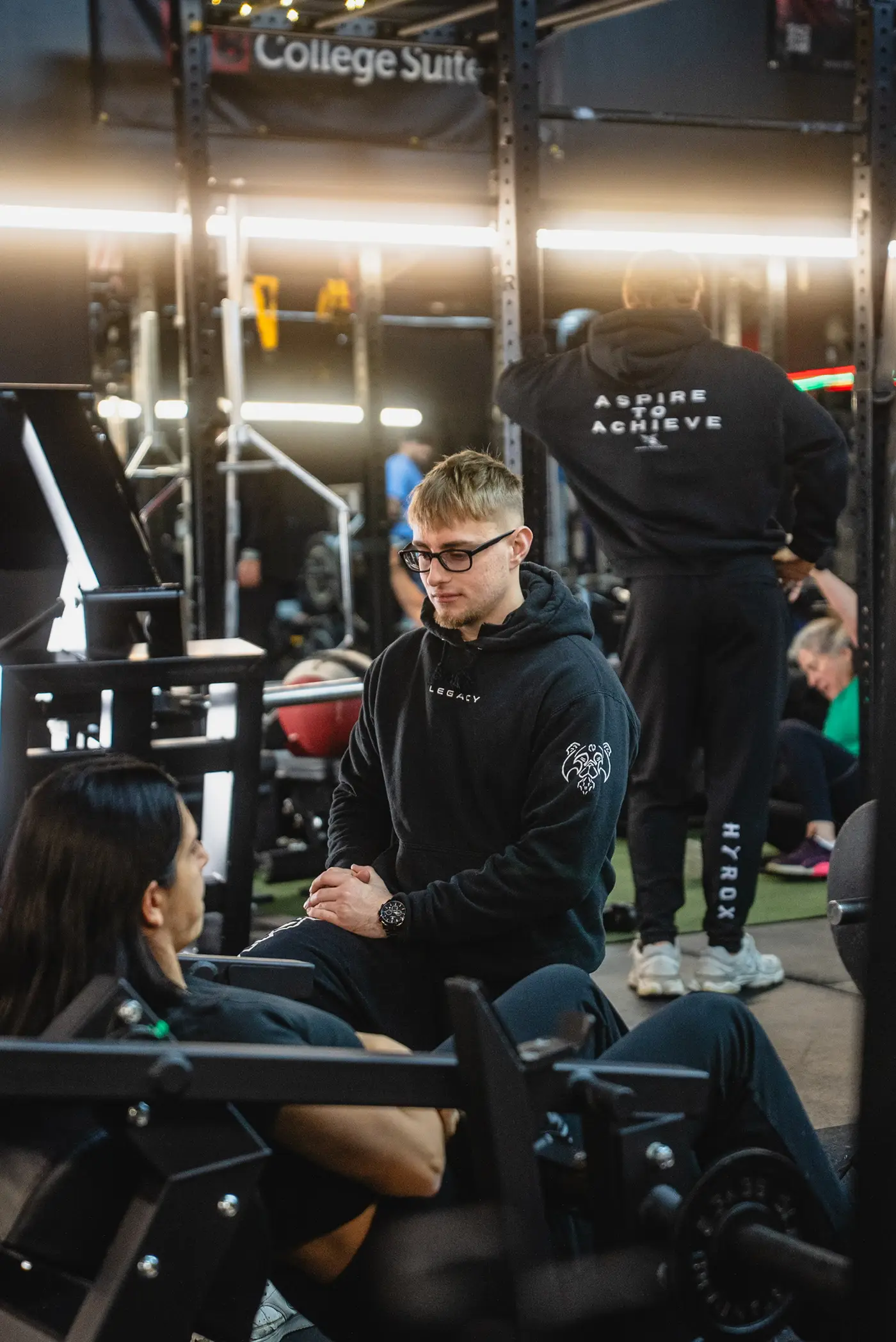 An Aspire coach working one on one with a client on the training floor